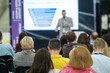 © Anton Gvozdikov - Business professionals attending a conference presentation. Speaker giving lecture with slide presentation to engaged audience in a corporate event setting.