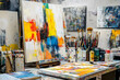 © AungThurein - An artist’s studio filled with canvases, brushes, and paint splatters