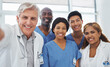 © DavisShared/peopleimages.com - Selfie, portrait or doctors with smile for healthcare, professional or pride with diversity in hospital. Medical specialist, surgery or happy in team for synergy, collaboration or trust in solidarity