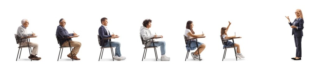 Wall Mural - Teacher standing in front of young and older people in school chairs