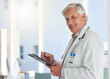 © peopleimages.com - Portrait, mature man and doctor with clipboard in hospital, wellness and healthcare with expert. Face, medical and professional with documents for routine, insurance or checklist with skills or smile