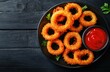 © BerkahStock - Crispy Onion Rings with Ketchup