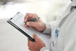 © peopleimages.com - Hands, prescription and writing with doctor in hospital, closeup for checklist or medical aid. Clipboard, diagnosis and document with healthcare professional person in clinic for planning or research
