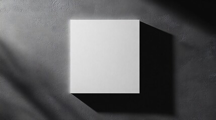 Wall Mural - A single white square, slightly off-center, on a dark grey background with shadows