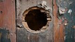 © fivan - Hole punched through a wooden wall with splinters and debris scattered around