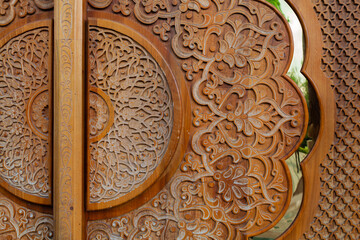 Carved wooden door decoration. Floral design pattern. Close up fragment. Khiva (Xiva), Uzbekistan