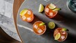 © Kartik - Top view of cold alcohol margarita cocktails with pieces of lime on grey tabletop