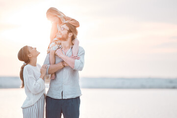 Poster - Sunshine, shoulders and parents with child on beach for bonding, relaxing and travel together in nature. Family, morning and mom, dad and girl by ocean for holiday, vacation and adventure by mockup