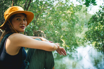 Lovely Happy Asian woman relax in the mangrove forest outdoor activity.