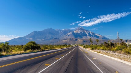 Wall Mural - A long road with a mountain in the background