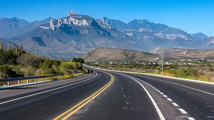 Wall Mural - A long road with a mountain range in the background