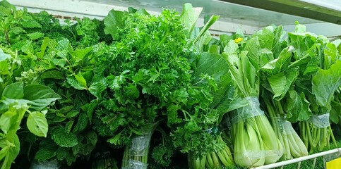 fresh green vegetables for sale. fresh green vegetables on shelves in grocery stores for sale