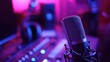 © arthit - A close-up of a professional condenser microphone on a studio desk, with headphones and music equipment visible, showcasing the tools of a recording artist.