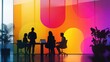 © Inkreatif - Silhouettes of business people in a modern office setting with a colorful gradient wall behind them.