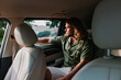 © SHOTPRIME STUDIO - Man sitting in a car, looking out the window, with sunlight streaming in through the glass Soft interior colors create a calm ambiance