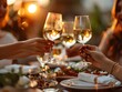 © Bussakon - Business Team Celebrating Dinner After a Big Win Toasting With Wine Glasses