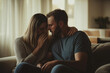 © Miqdad_Creates - A couple is sitting on a couch, the woman is crying and the man is comforting her.