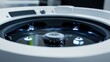 © P.G - A cleaning robotas water reservoir in sharp focus, with emphasis on the filling cap and water level indicators.