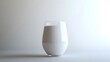 © Wuttichai - Artfully Poured Glass of Rich Velvety Milk Reflecting the Surrounding Minimalist White Space