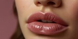 Close-up of beautiful young woman’s sexy pink lips with glossy pink lip gloss. Beauty, cosmetic, and makeup concept