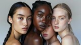 Four women with different skin tones are standing close together