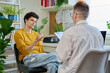© Valerii Honcharuk - Young male patient in therapy with psychologist counselor in office