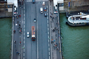 Aerial view of Paris with busy bridge, many pedestrians and cars