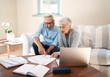 © Chanelle2000/peopleimages.com - Old couple, paperwork and investment with banking summary elderly husband and wife on couch in home. Laptop, report or senior people reading retirement savings growth, insurance policy or documents