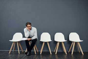 Canvas Print - Recruitment, chairs and row for bored man with vacancy, wait and cv file or book. Hiring, tired and employment candidate mockup with document, work opportunity and queue for human resources interview