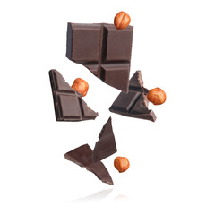 Poster - Pieces of tasty chocolate and hazelnuts falling on white background