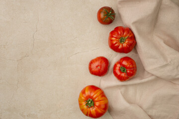 Red ripe organic tomatoes in a plate on the table