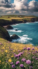 A stunning view of a coastline with a field of purple wildflowers in the foreground and a blue ocean with white waves in the background.