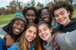 © Rattanapon - Multicultural young school people taking photo together with smiling.