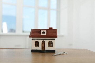 Wall Mural - House model and key on wooden table indoors