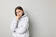 © New Africa - Portrait of scared woman on light background. Space for text