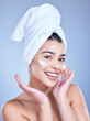 © Van Wyk/peopleimages.com - Portrait, woman and cosmetics with beauty, cream and dermatology on blue studio background. Happy person, face and model with towel, grooming routine and creme with treatment, wellness and soft skin