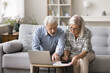 © fizkes - Serious couple sit on sofa, count monthly expenses, check mortgage payments, busy in finances analysis, family budget management, feel concerned by lack of money, having financial difficulties or debt