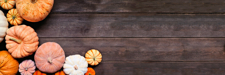 Sticker - Fall corner border of pumpkins of various sizes and colors over a rustic dark wood banner background. Above view with copy space.