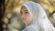 © anis rohayati - Beautiful Indonesian woman muslim glamour costume bride model in white hijab background wallpaper AI generated image