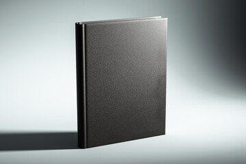 Wall Mural - Black hardcover book mockup on a light grey background with shadow. 3D Rendering