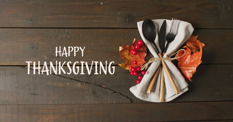 Sticker - Image of happy thanksgiving text and cutlery and autumn leaves over wooden background