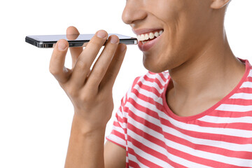 Poster - Young man recording voice message via smartphone on white background, closeup