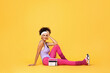 © New Africa - Aerobics. Woman with radio receiver on orange background