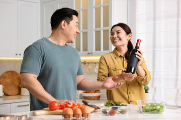 Wall Mural - Happy lovely couple cooking together in kitchen