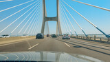 Vasco da Gama Bridge stretches over the Tagus River, carrying vehicles in bright daylight.