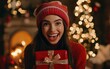 © Adriana - Excited attractive young woman holding Christmas present on Christmas night