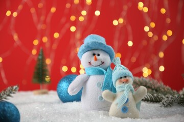 Wall Mural - Cute decorative snowmen and other Christmas decor on artificial snow