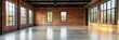 © Elmira - The spacious interior features large windows allowing natural light, highlighting the exposed brick walls and smooth concrete flooring in a modern industrial setting