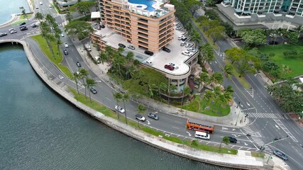 Wall Mural - tilt aerial footage of skyscrapers, hotels and condos, Ala Wai Canal, lush green trees, the Punch Bowl and cars driving on the street in Honolulu Hawaii USA