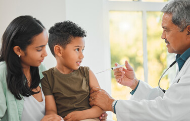 Canvas Print - Pediatrician, woman and child with injection, health and vaccine for growth or development in clinic. Mother, boy and doctor with needle at hospital for immunity, routine check and illness prevention